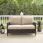 Kiawah Outdoor Loveseat in Brown Resin Wicker & Sand Cushions